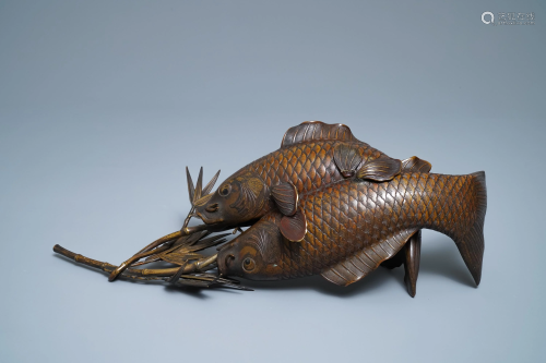 A Japanese bronze group depicting two koi fish,…