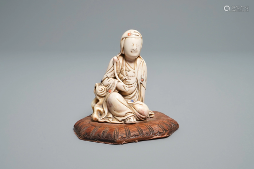 A Chinese inlaid soapstone figure of a seated…