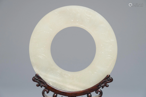 A Chinese pale celadon jade bi disc, Ming or earlier