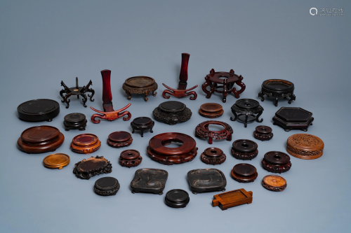 A collection of 33 Chinese carved wood stands…