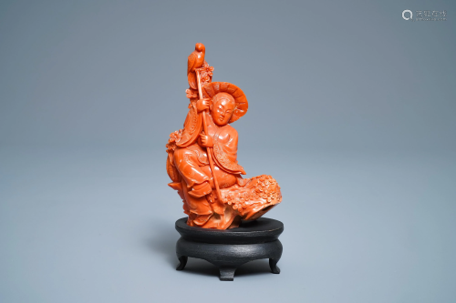 A Chinese carved red coral group of a boy with a