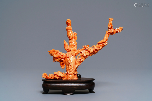 A Chinese carved red coral group of a lady among