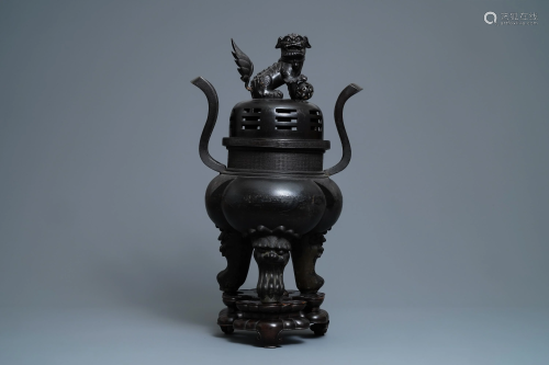 A large Chinese bronze incense burner and cover on