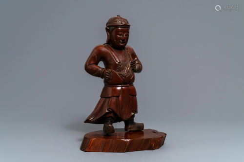 A tall Chinese lacquered wood figure of a guardian,