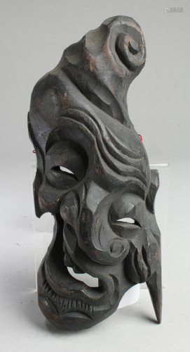 A Carved Wooden Face Ornament