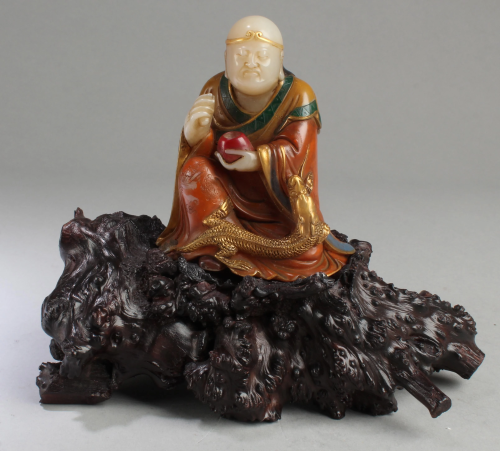 A Soapstone Figurine with Wooden Stand