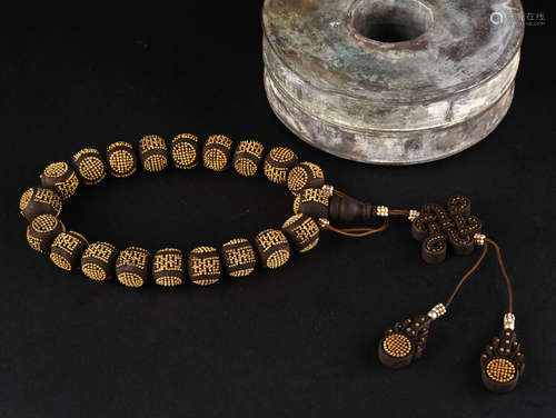 A SILVER INLAID ALOESWOOD ROSARY, QING DYNASTY