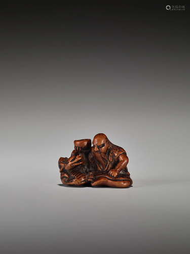 A RARE WOOD NETSUKE OF CHINNAN SEN…