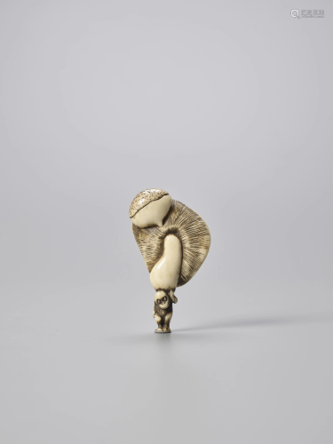 AN AMUSING STAG ANTLER NETSUKE OF A SMAL…