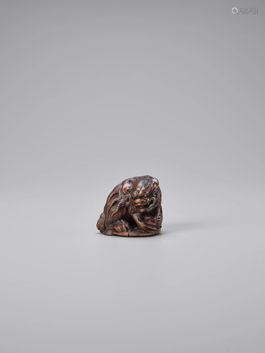 MASATOMO: A WOOD NETSUKE OF A SHISHI WITH …