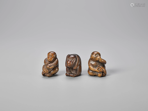 A GROUP OF THREE WOOD NETSUKE OF MONKEYS