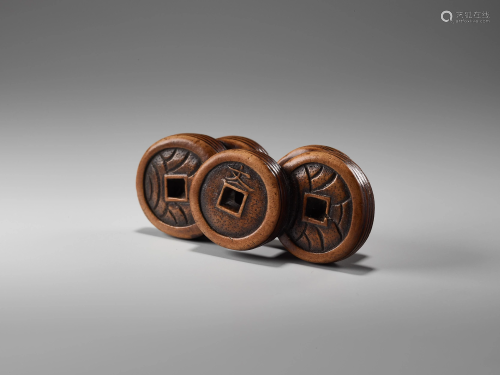 A WOOD NETSUKE OF A GROUP OF COINS