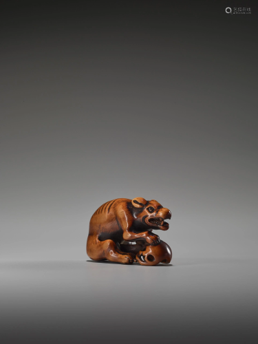 A POWERFUL WOOD NETSUKE OF A WOLF WITH …