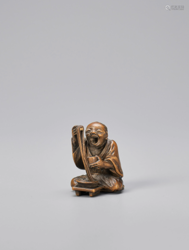 AN AMUSING WOOD NETSUKE OF A NOODLE EATER