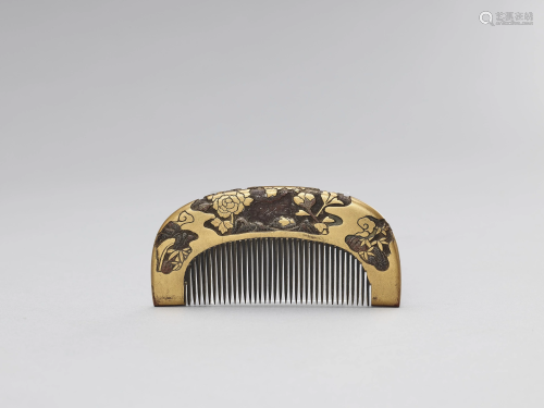 A GOLD LACQUERED COMB