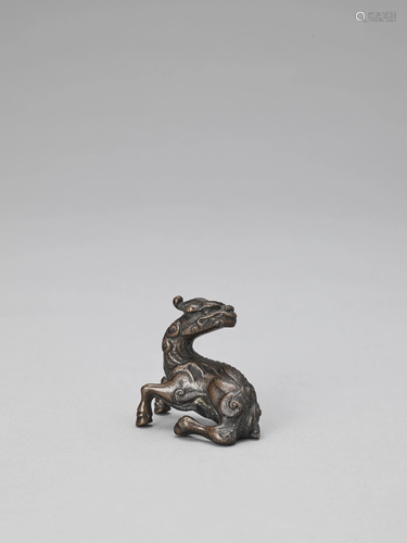 A BRONZE 'QILIN' SCROLL WEIGHT, MING