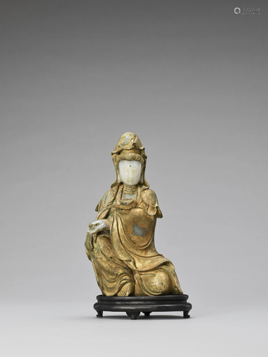 A LACQUER-GILT PALE CELADON JADE FIGURE OF G…