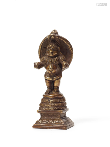 A RARE INDIAN BRONZE OF STANDING KRIS…