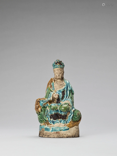 A FAHUA GLAZED POTTERY FIGURE OF GUANYI…