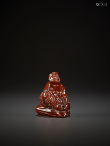 AN AMBER FIGURE OF A FISHERMAN, QING