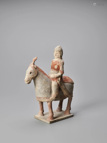 A TERRACOTTA FIGURE OF A HORSE AND RIDER