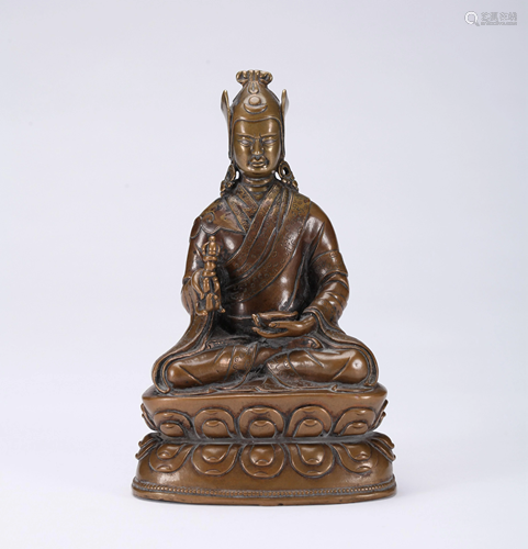 A CHINESE GILT BRONZE FIGURE OF A GURU,…