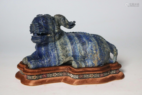 A CHINESE CARVED STONE MYTHICAL BEAST, QI…