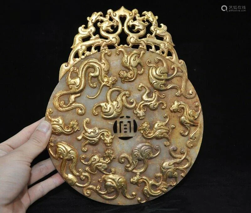 A NATURAL HETIAN JADE GILT DRAGON BEAST MI…