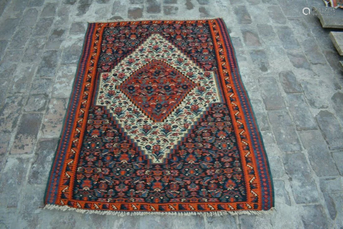 A VINTAGE AFGHANI WOVEN CAUCASIAN RUG.