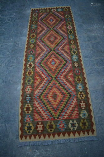 A VINTAGE AFGHANI WOVEN SHIRAZI AREA KILIM.