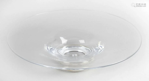 Four clear glass shallow bowls, each raised upon a