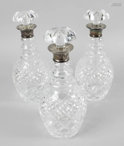 A set of three silver mounted glass decanters, eac…