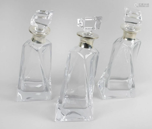 Three modern glass decanters each of square tap…