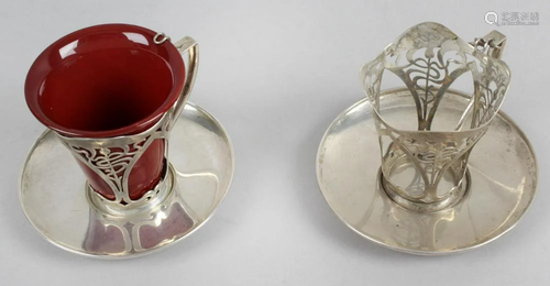 A pair of Art Nouveau silver coffee cup holders and