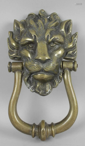 A solid cast brass door knocker, modelled as the head