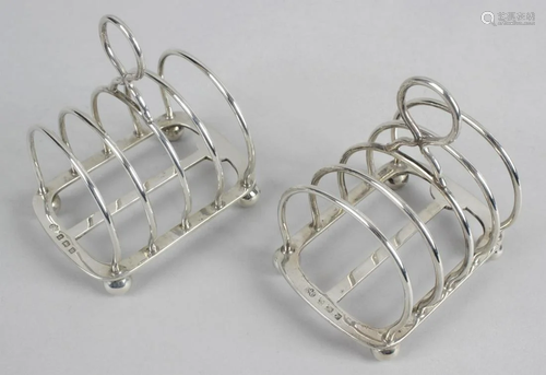 A pair of 1930's small silver toast racks, each of