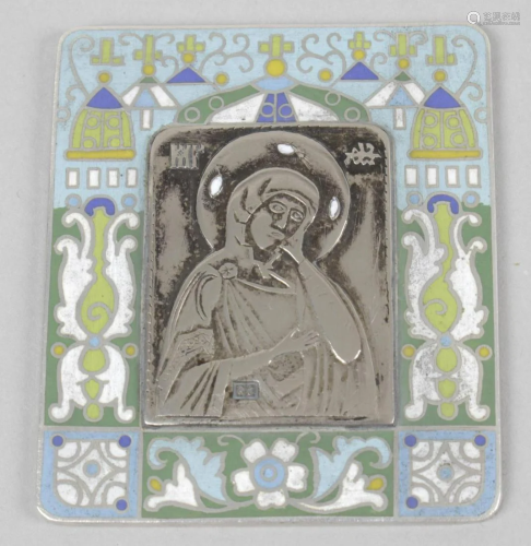 A small white metal religious picture or icon, with…