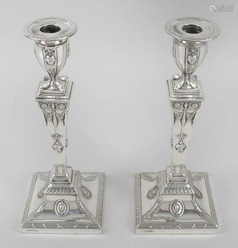 A pair of early George V silver mounted candlesticks in