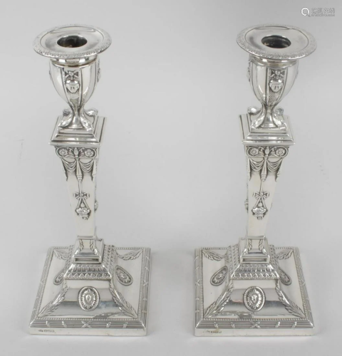 A pair of early George V silver mounted candlesticks in