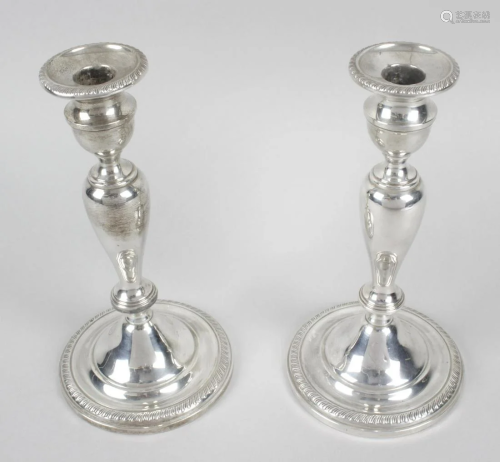 A pair of silver mounted candlesticks, probably