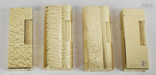 A group of four gold plated Dunhill cigarette lighters,