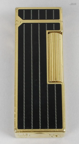 A Dunhill cigarette lighter, of rectangular form …