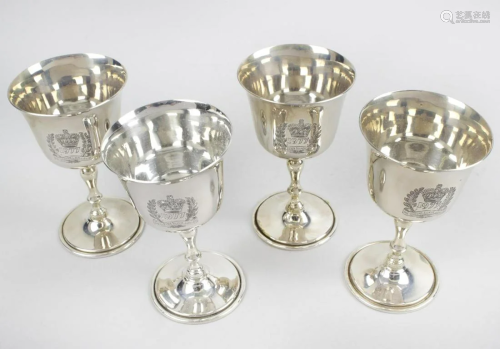A set of four small silver goblets commemorating…