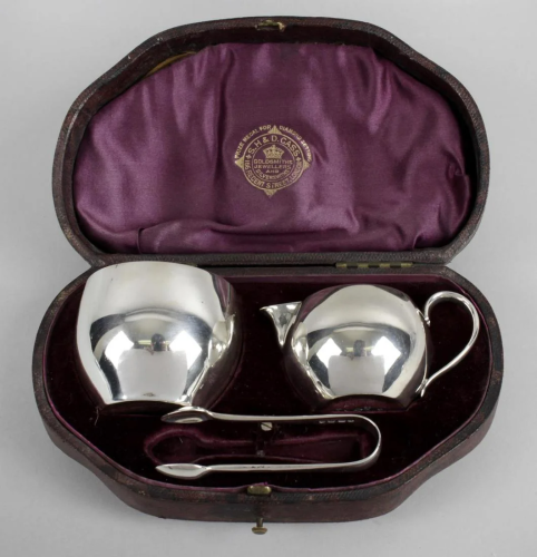 A cased Victorian silver set comprising a small cream