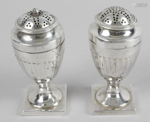 A pair of George III small silver casters, each of …