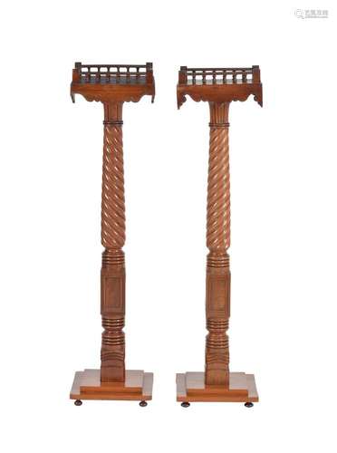 A pair of mahogany and brass strung torchere stands