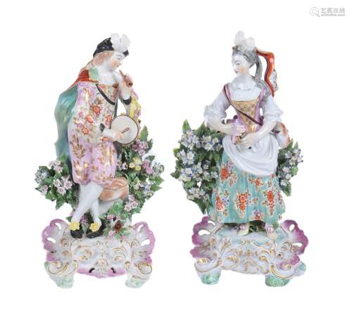 A pair of Derby porcelain bocage figures of a musician and companion