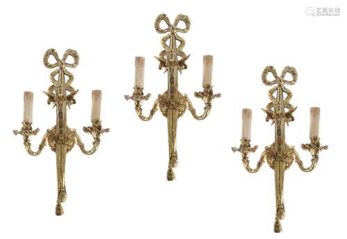 A set of three Continental gilt metal twin light wall appliques in Louis XVI taste