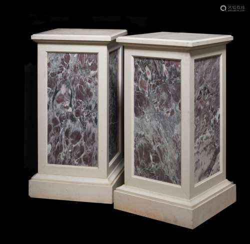 A pair of stone and fleur de pêcher marble inset plinths