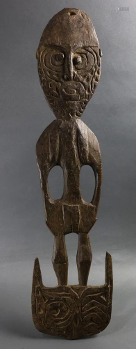 A Papua New Guinea hook figure with incised carv…